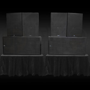 Meyer Sound CQ-2 loudspeakers with dual 18 inch 700-HP subwoofers on risers at a live event